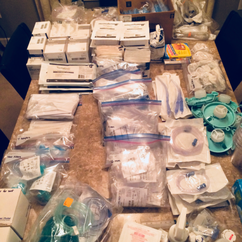 Photo of a large table full of medical, specifically, respiratory supplies.