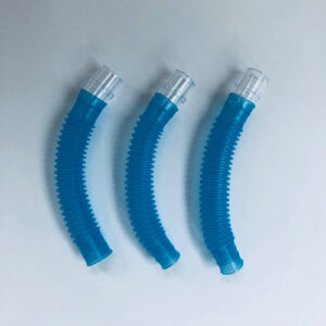 Photo of three short sections of blue corrugated tubes, with plastic adapters connected to one end of each