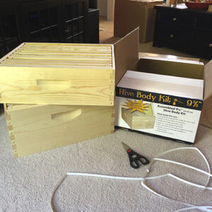 Photo of boxed beehive next to unboxed beehive box